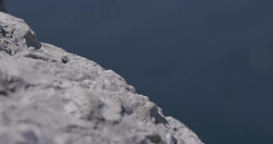 Safety rope falling from a mountain by the sea