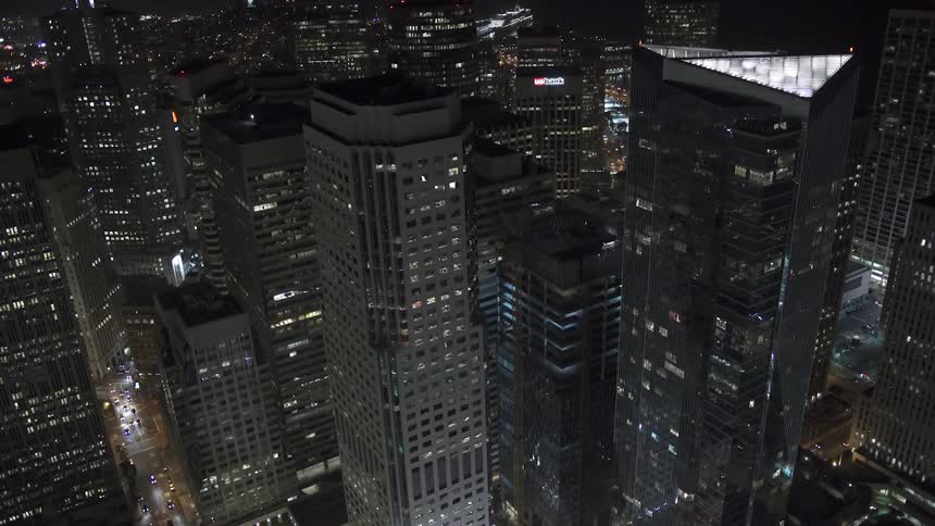 A city skyline full of towering skyscrapers and buildings at night
