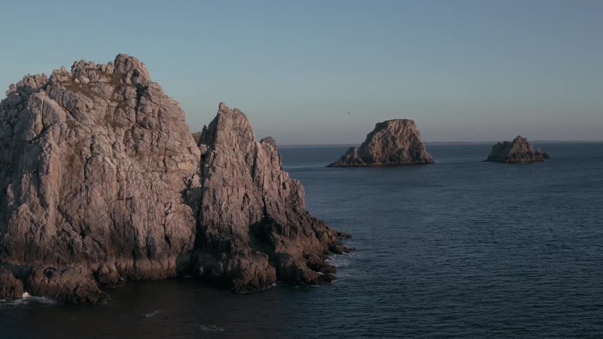 A string of small mountainous islands in an ocean