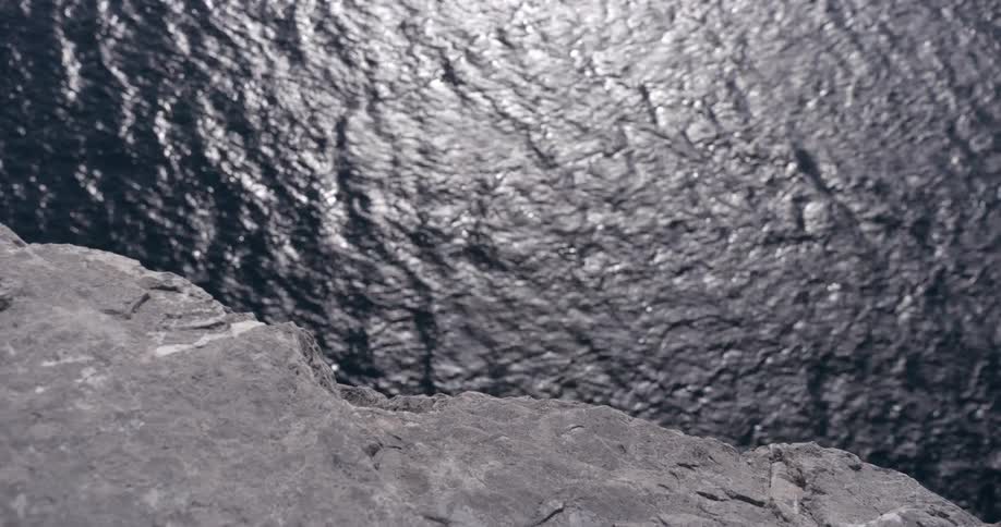 A rock path close to the river bank as the wind the river gently