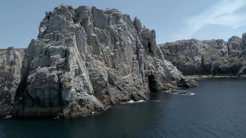 A rugged coastline with a steep weathered cliff