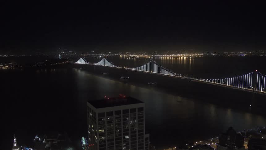 Aerial view of a lit up city bridge