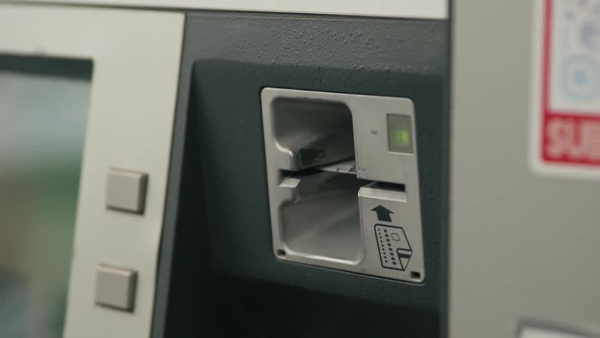 Woman inserts and removes payment card into card reader
