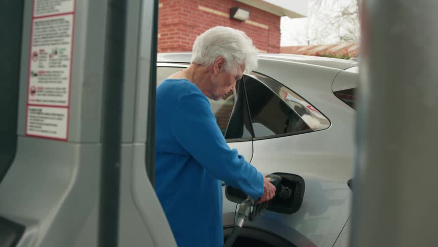 A woman is filling her car with gas