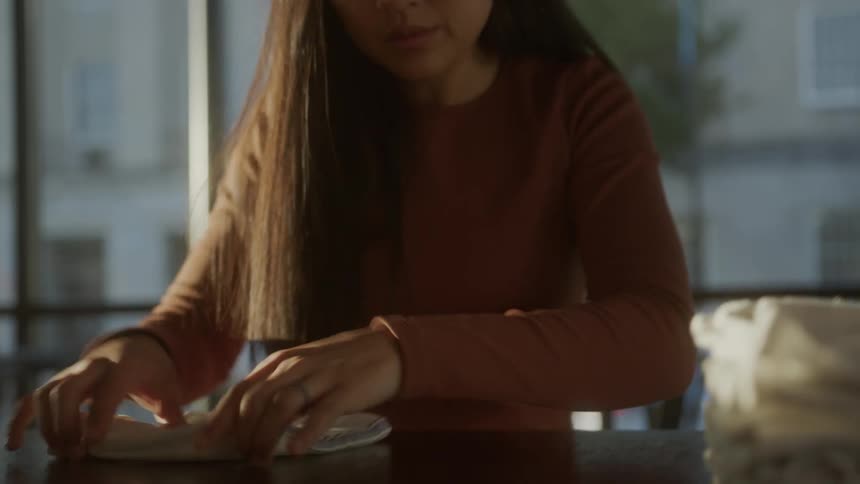 A women folds hand towels neatly