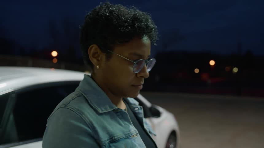 A woman inserts her credit card to pay for gas