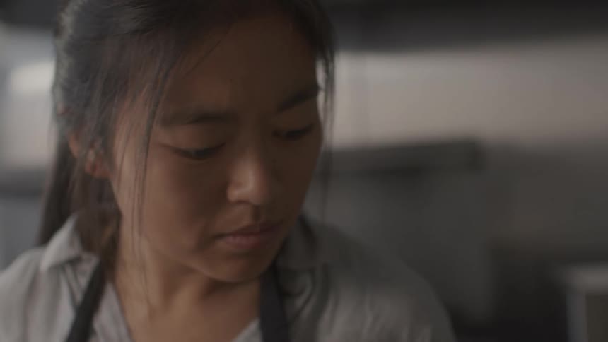 An asian woman working inside a services business