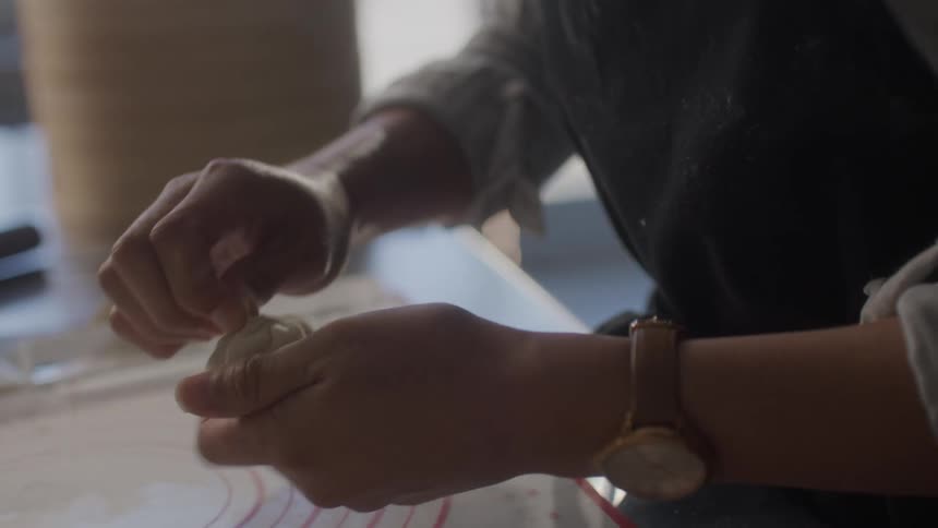 Closeup on a womans hands preparing on nikuman