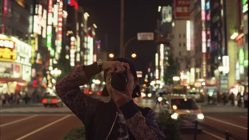 A clip of a photographer taking pictures on the street