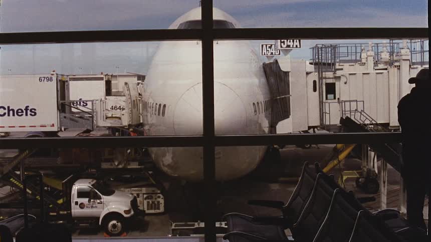 A plane loading passengers at an airport