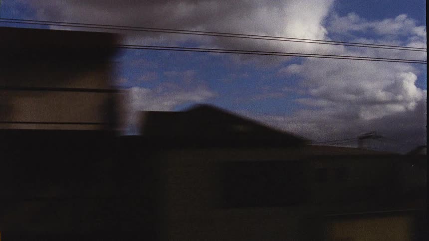 Moving point of view of an urban city on a blue sky day with clouds