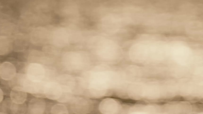 Sunlight bokeh from waves moving across a body of water