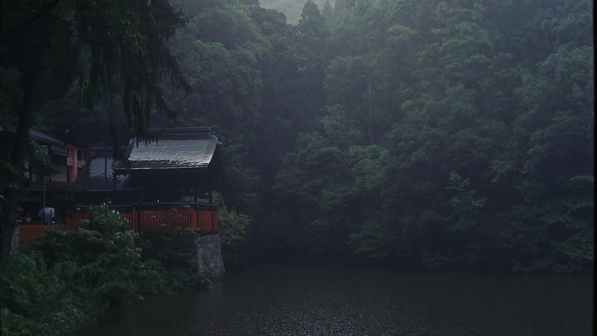 It is raining on the lake and forest