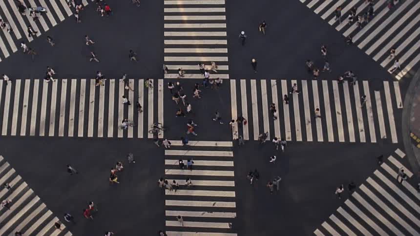 View from above of a huge population of pedestrians crossing an intersection with crosswalks