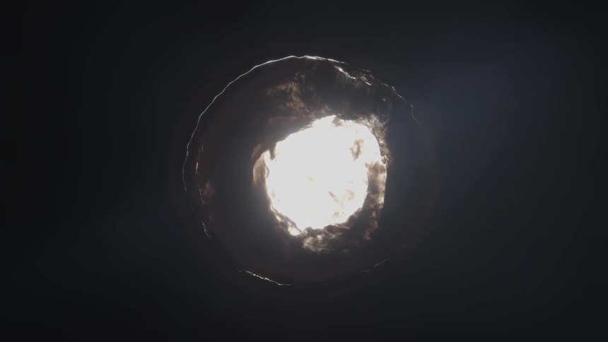 A bright white circular object emerges from a dark background and then contracts