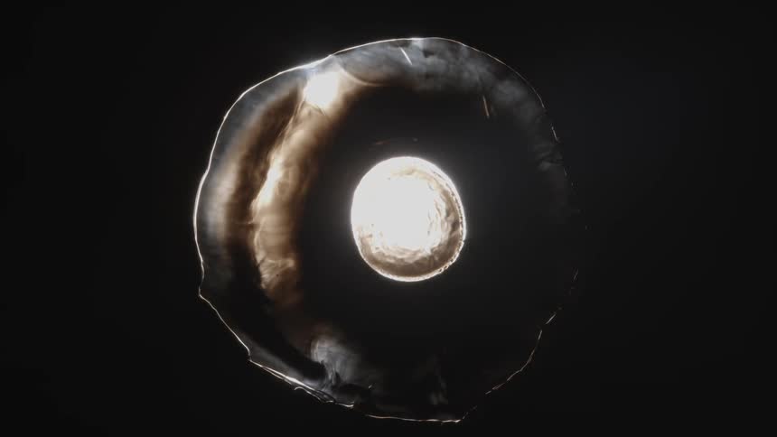 Abstract and luminous sphereshaped fluid expanding on a black background and disappearing