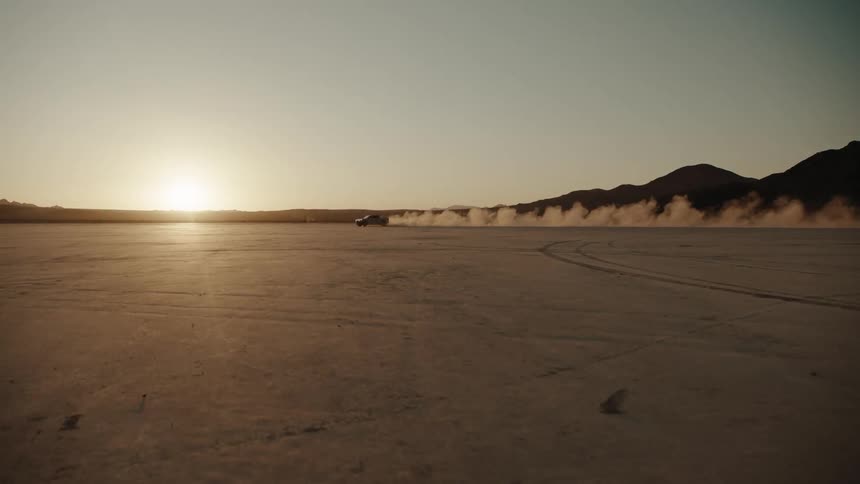 A clip of a smoky vehicle moving on the desert
