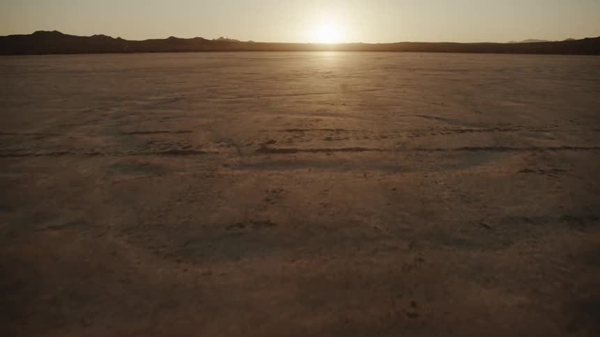 A view of a desert with dirt on the ground