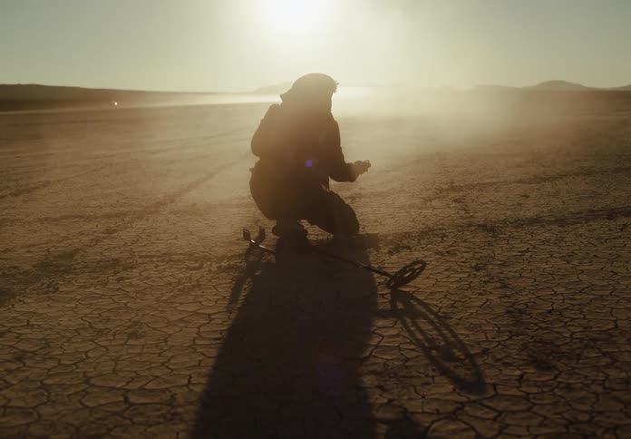 A man digs up something he found with his metal detector