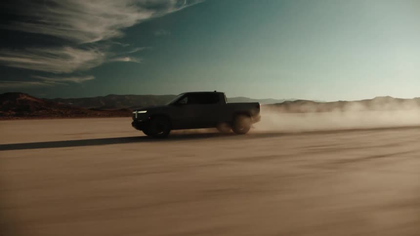 A truck drives across a desert