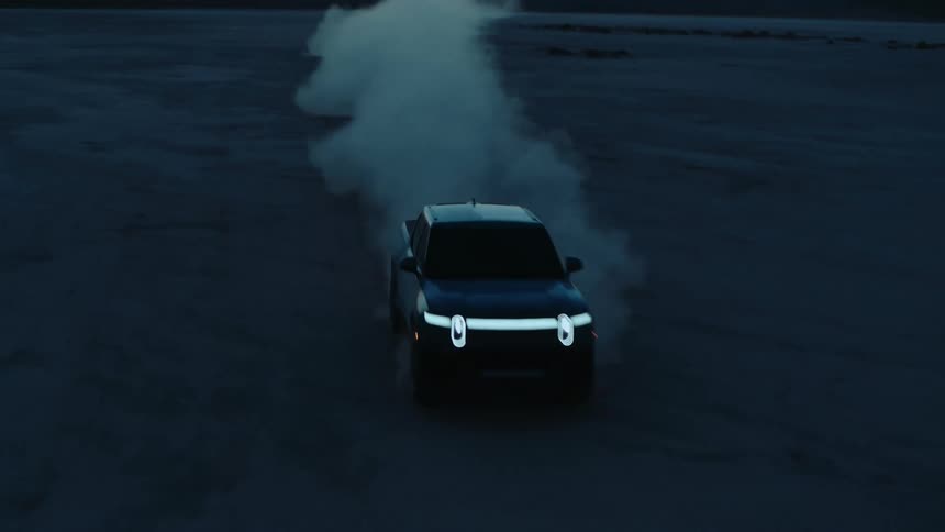 A truck speeds down the desert