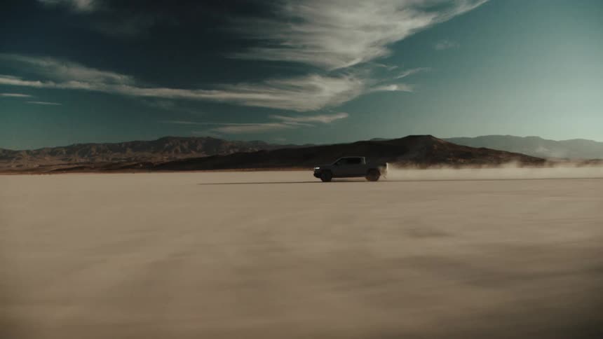 A truck races across a desert