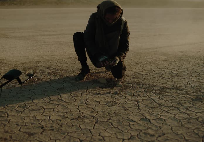 A clip of a person digging the soil to find a device