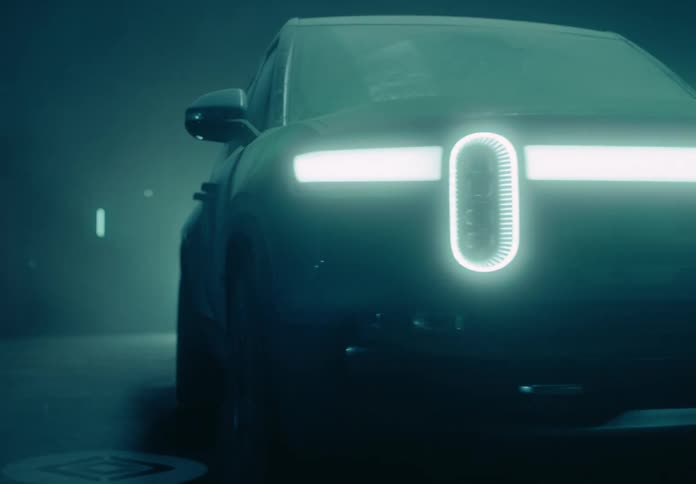 Pickup truck inside a dark interior illuminated by lights and led headlights