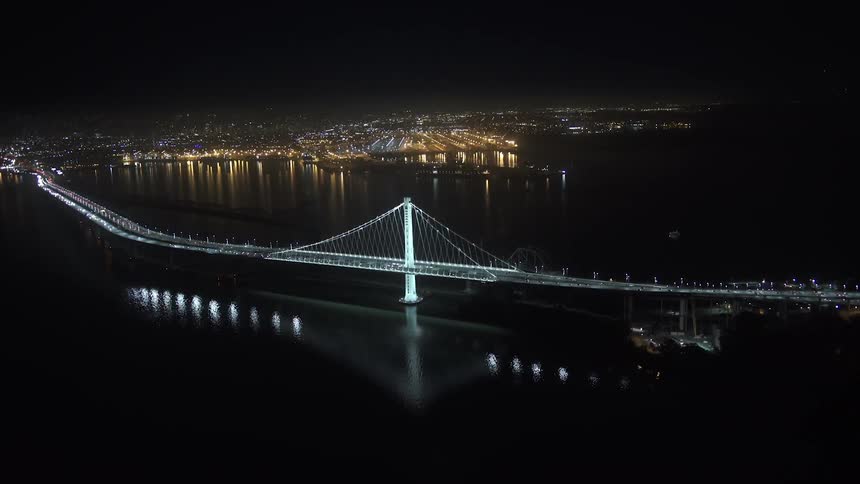 Aerial view of a lit up city bridge