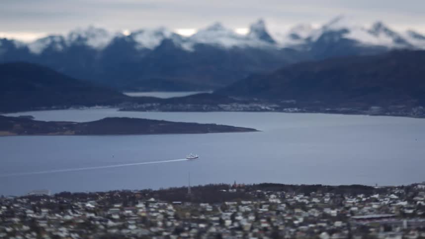 A clip of a boat speeding past a city in North Norway