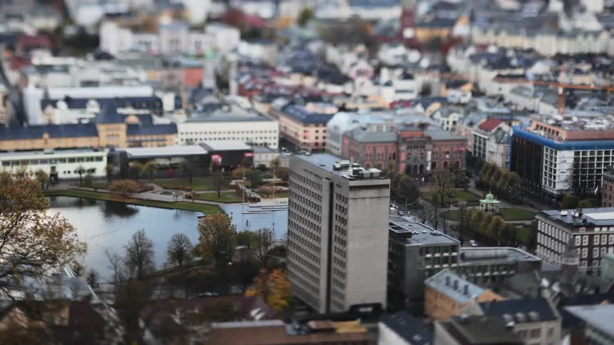 Aerial of a metropolis next to a river on an autumn day
