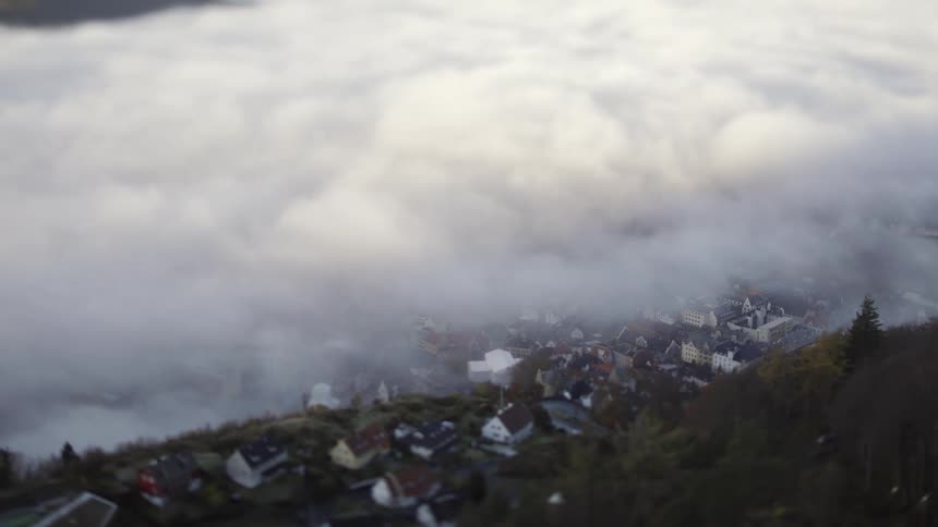 Heavy fog bank rolls across town on mountainside
