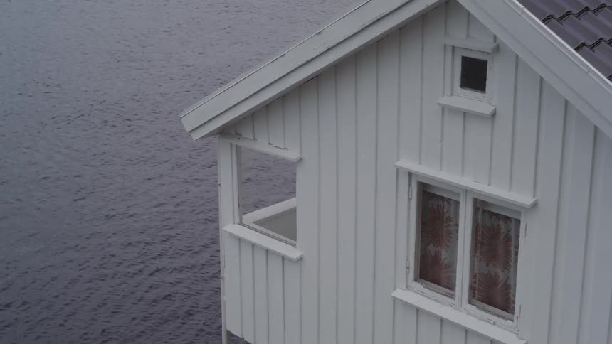 A house sitting next a body of water