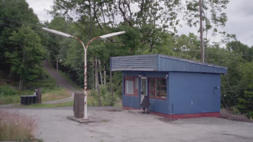 An abandoned gas station near a forest