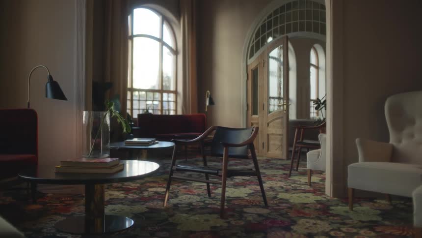 Multiple open arched windows let light into rooms with floral carpet