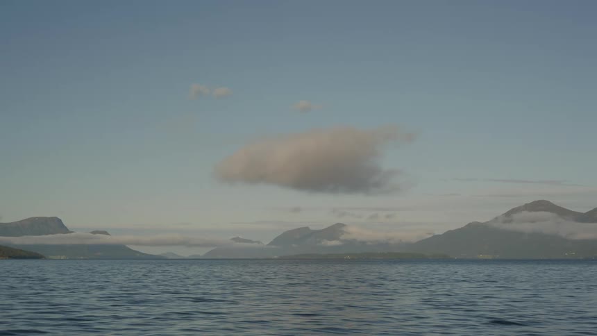A mountain range beyond a large body of water
