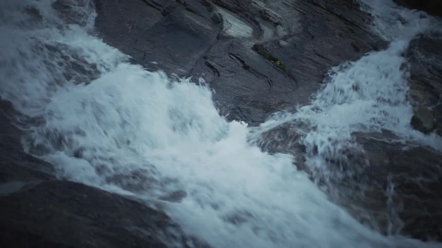 Flowing water falling amid rocks in a river