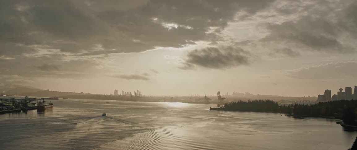 Pan shot revealing Vancouver's downtown and Stanley park as the sun rises