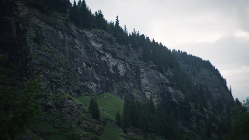A small waterfall falls off the mountain