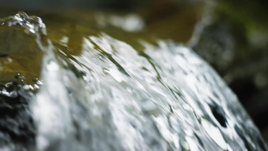 Running water free falling on a rock in a river