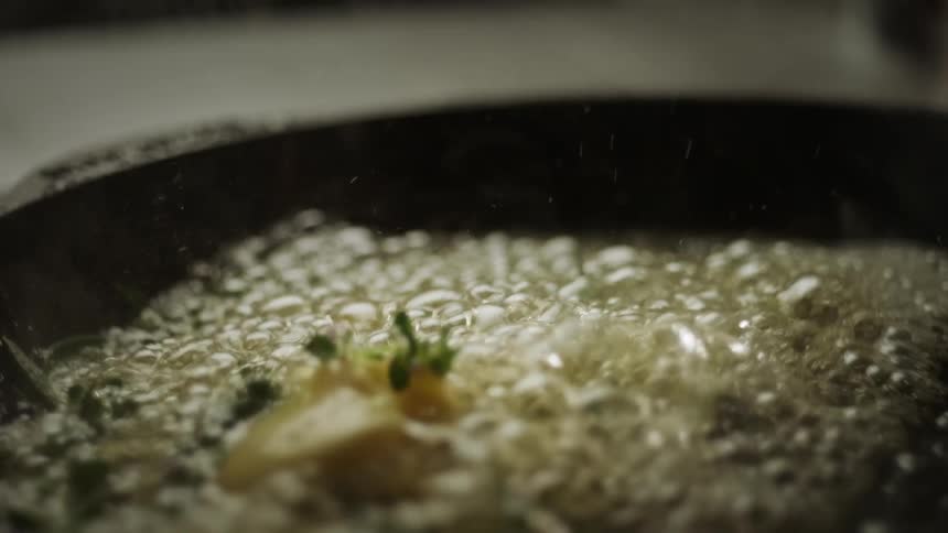 A person is melting butter in a pan