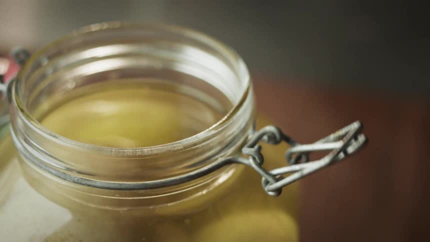 Person unlatches lid and flips it to open pickle jar
