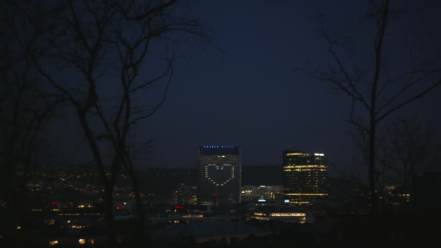 The lights in the window make the shape of a heart