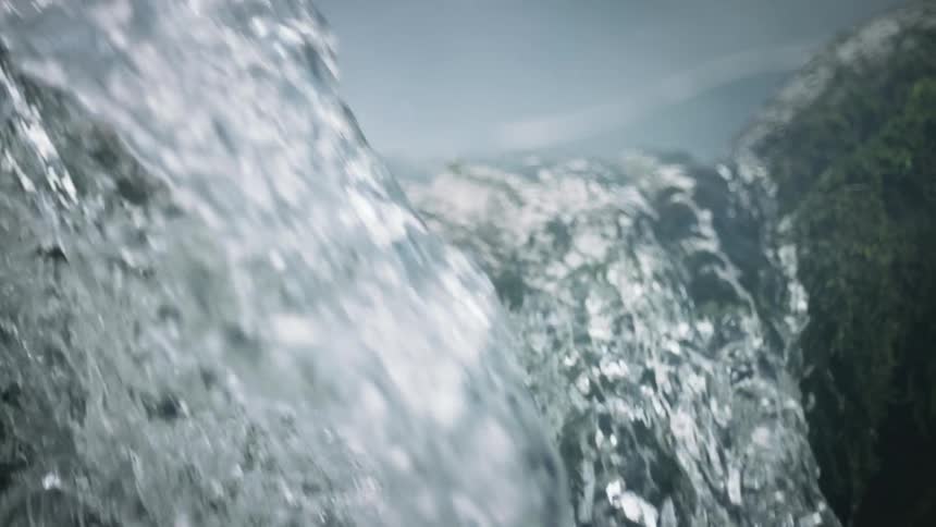 Closeup of the water of a river in free fall in slow motion