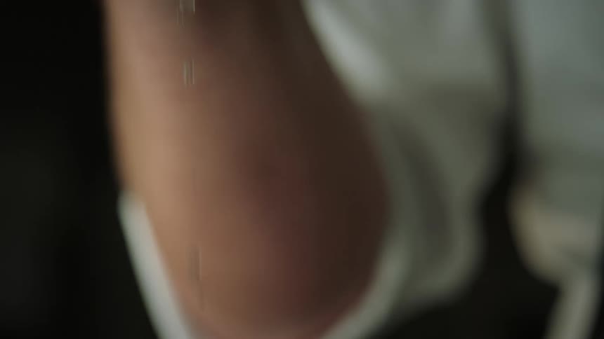 A persons hand squeezing a lemon in slow motion