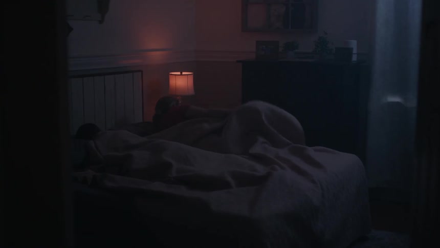 Woman checks time and gets out of bed at night without waking sleeping partner