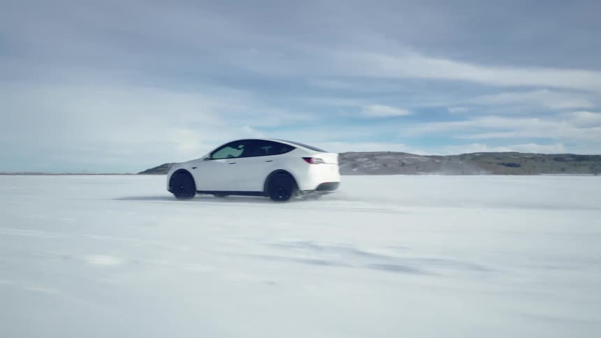 Electric car speeds away, driving on a frozen lake