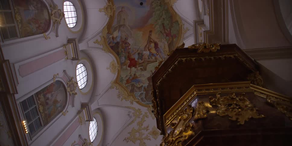 Upward view of the ceiling and windows with arts decorated architectures in a church