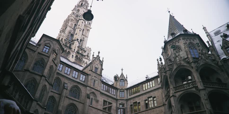 Cathedral with large towers in a square and on a cloudy day