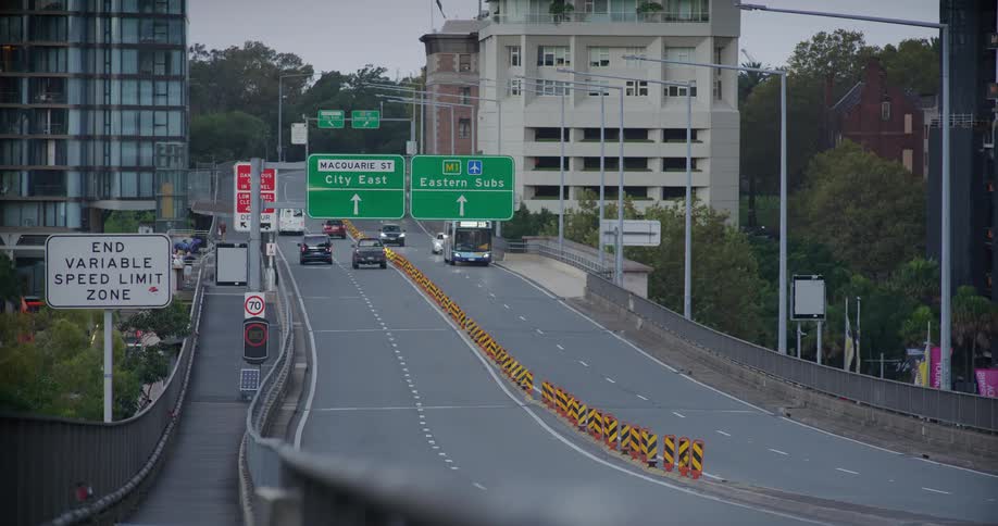 Traffic moves down a road in a city